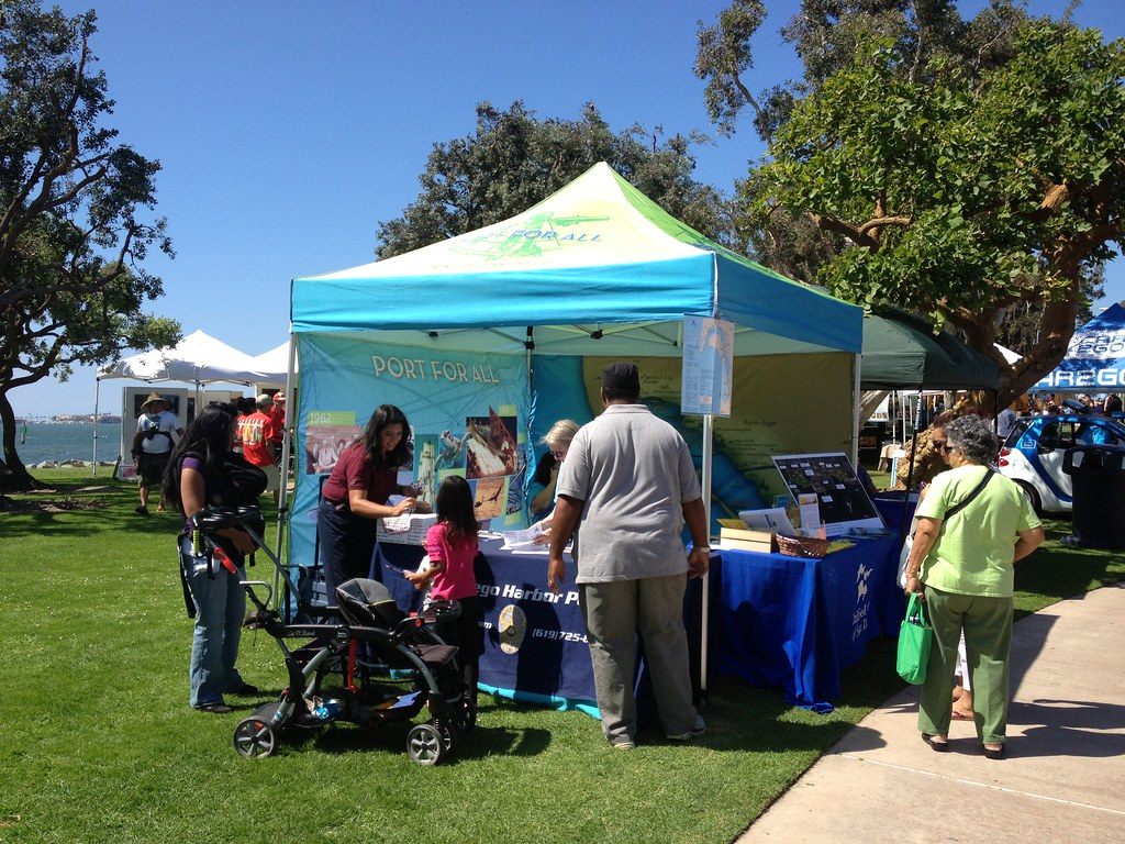 Families stopping at a Port of San Diego information tent on the lawn at the 2013 Chula Vista HarborFest