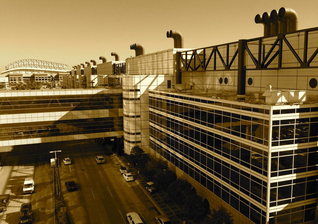 Sepia view along the George R. Brown Convention Center roofline and the enclosed skybridge crossing the street below