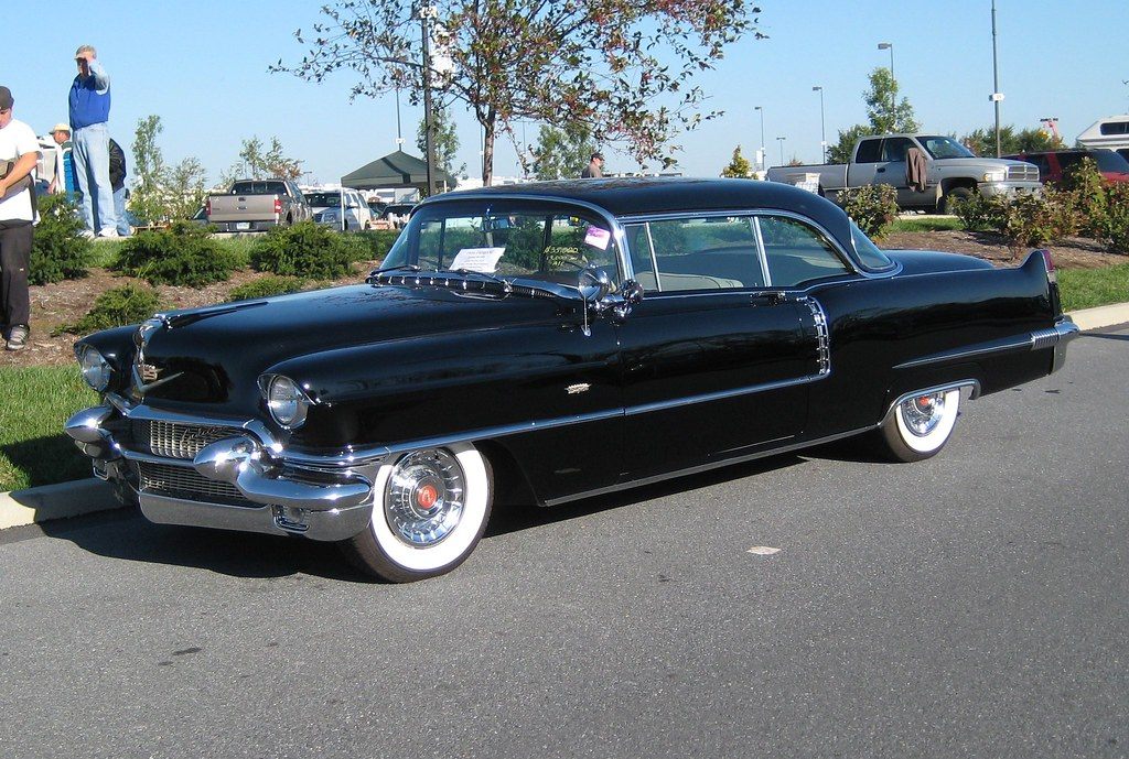 A black 1956 Cadillac Coupe de Ville with whitewall tires parked on the show field at the AACA Hershey fall meet