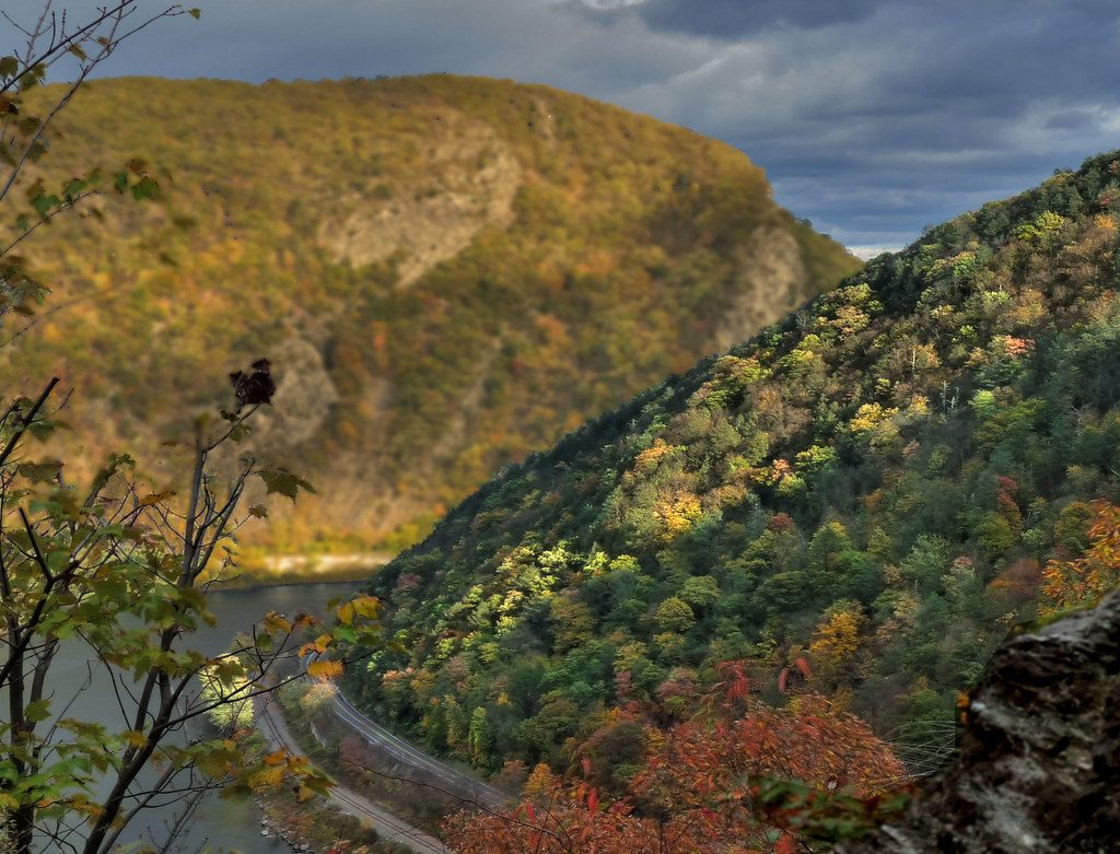 Autumn colour on the ridges of the Delaware Water Gap in late afternoon light, with the river and a rail line below