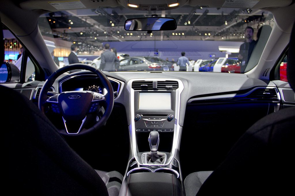 The 2012 LA Auto Show floor at the Los Angeles Convention Center seen through the windshield of a display car