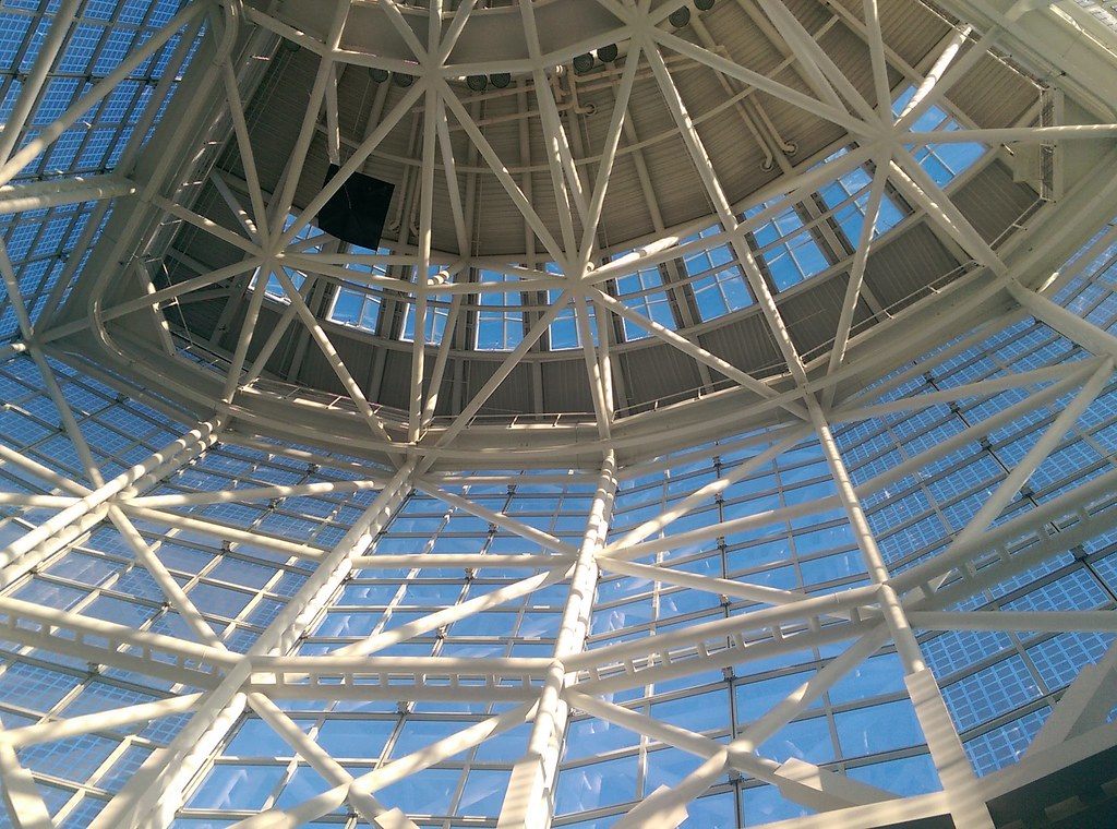 Looking up into the white steel lattice and glass roof of the LACC entrance rotunda