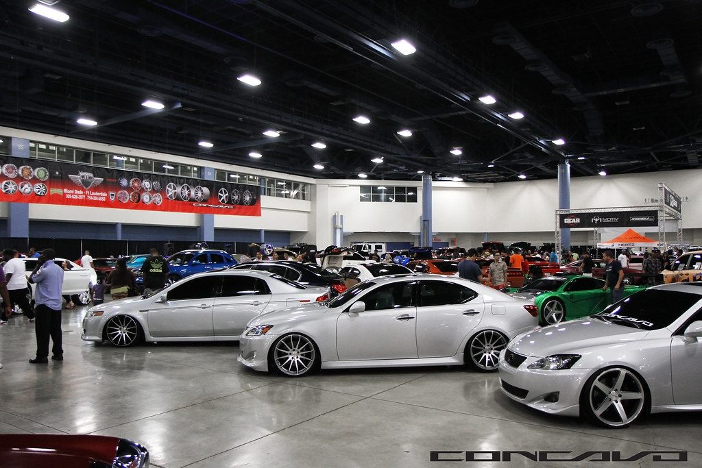 Rows of customized cars and visitors on the exhibit floor at the 2013 DUB Show in the Miami Beach Convention Center