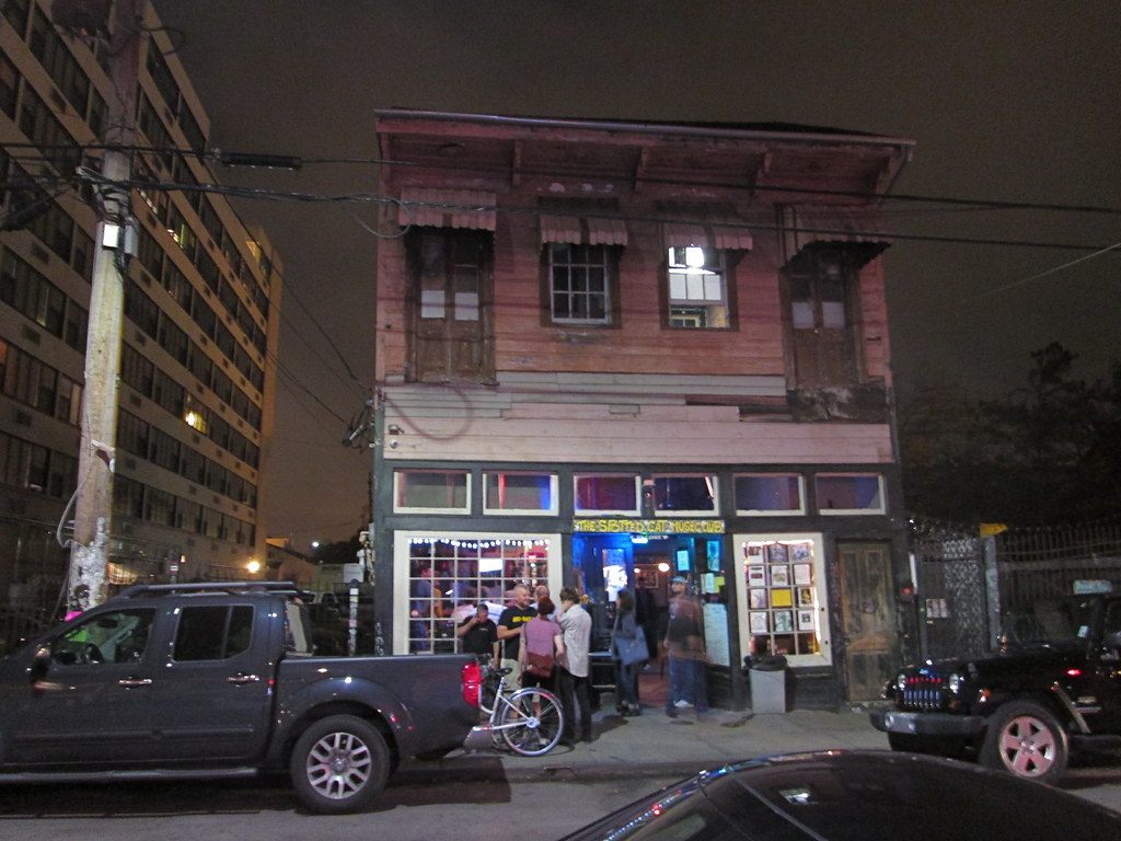 People gather at night outside the Spotted Cat music club, an old two-story building on Frenchmen Street in New Orleans