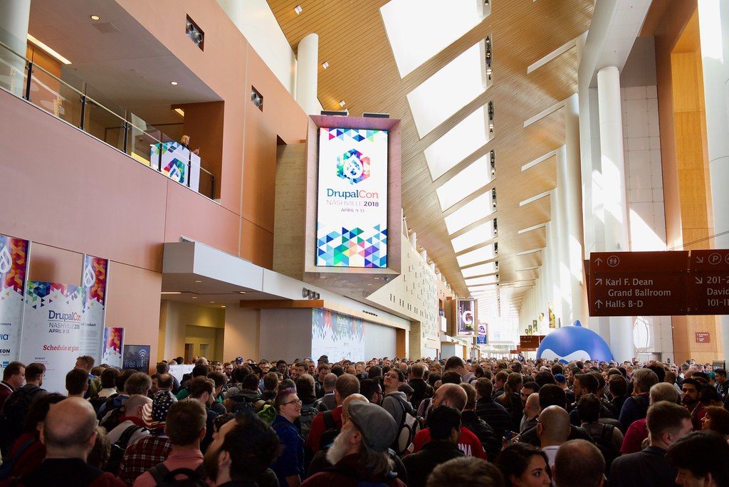 Thousands of DrupalCon 2018 attendees packed into the Music City Center main concourse under the wood-slat ceiling