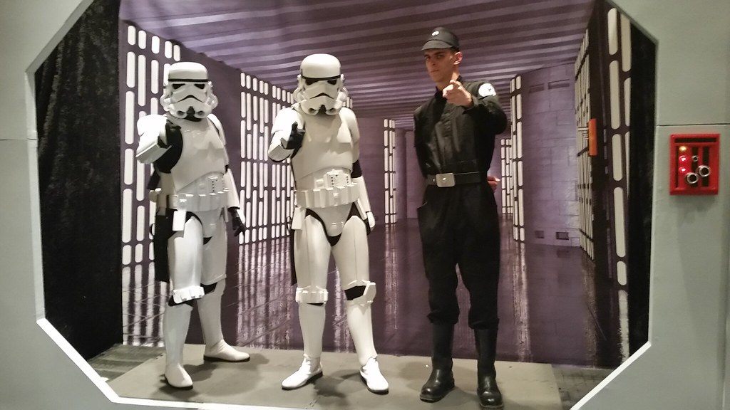Two stormtrooper costumers and an Imperial officer posing in a Death Star corridor photo set at Star Wars Celebration Orlando 2017 in the Orange County Convention Center