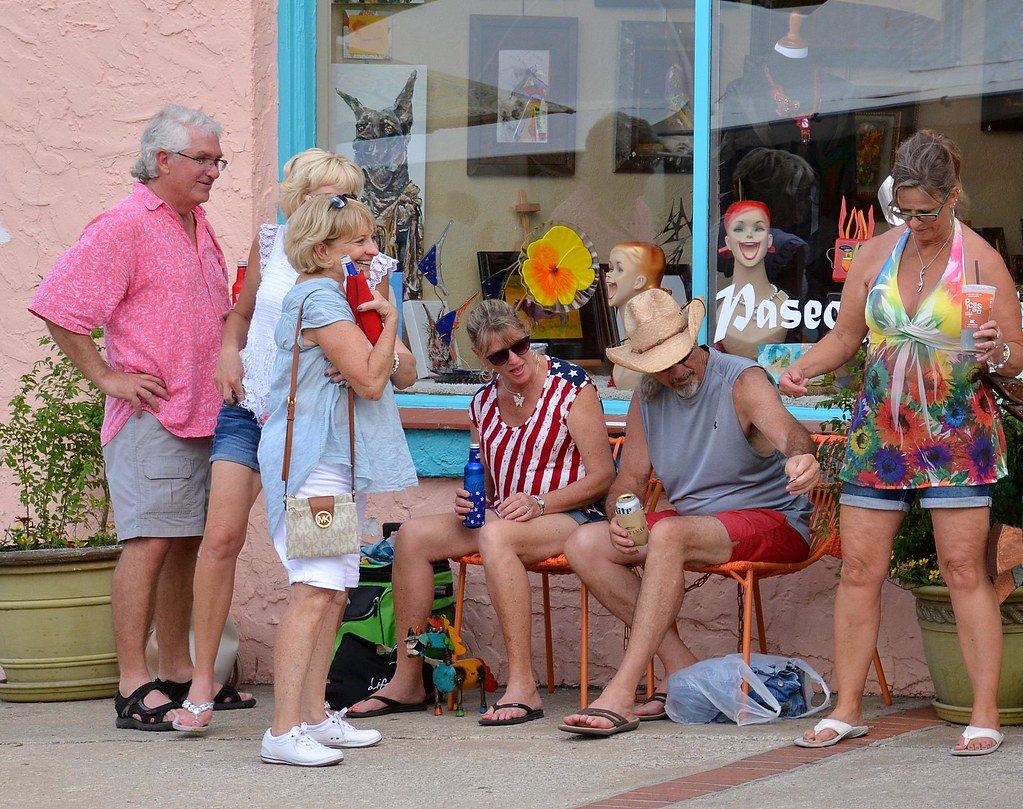 Festivalgoers chatting outside a colorful gallery storefront during the Paseo Arts Festival in Oklahoma City