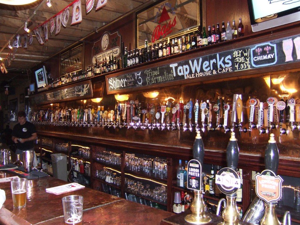A long wall of beer taps and bottles behind the bar at TapWerks Ale House in Bricktown