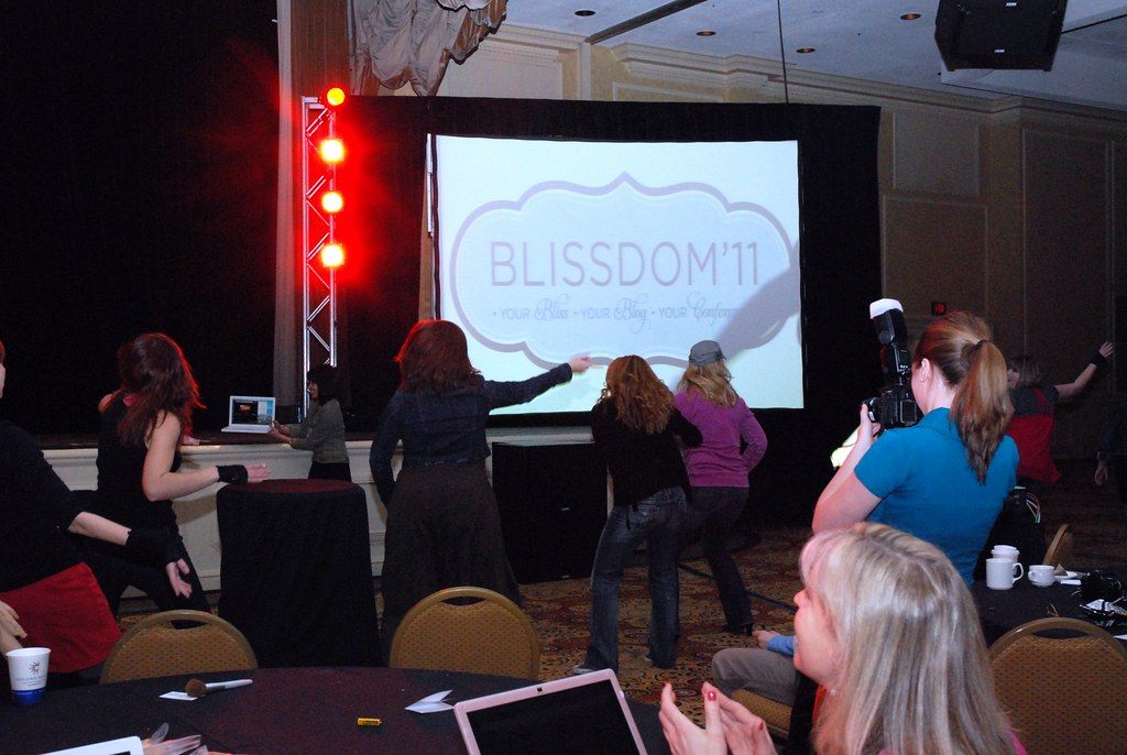 Blissdom 2011 attendees dance in front of the stage screen in an Opryland ballroom