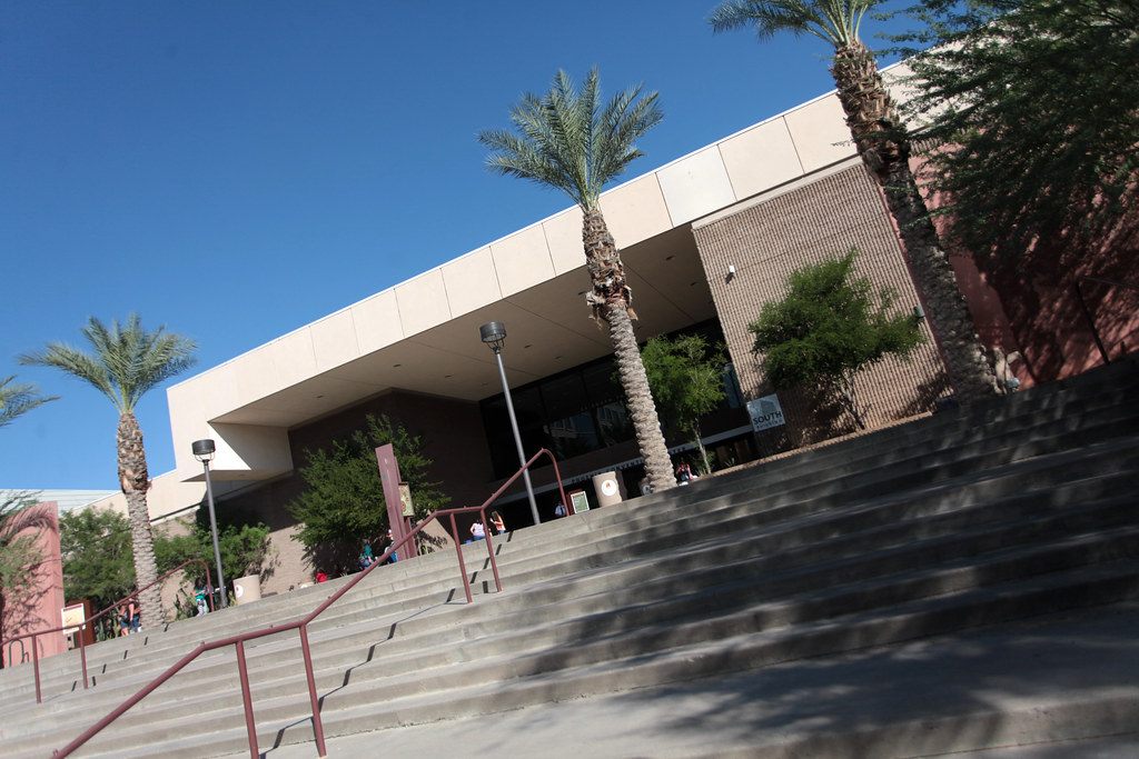Wide outdoor stairs, palm trees and a flat-roofed entrance of the Phoenix Convention Center under a clear blue sky