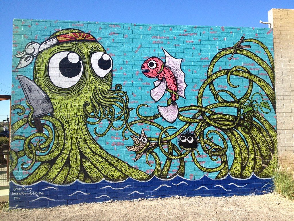 A big mural of a cartoon octopus, a fish and a starfish on a brick wall on Roosevelt Row in downtown Phoenix