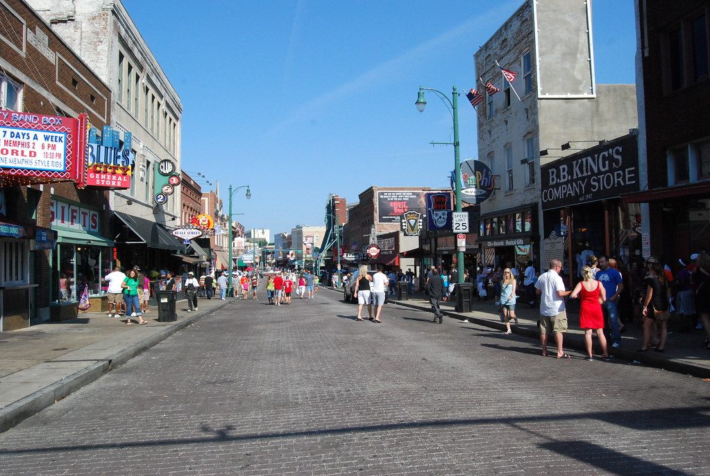 Visitors stroll the brick pavement of Beale Street past B.B. King's and the Band Box on a sunny afternoon in Memphis
