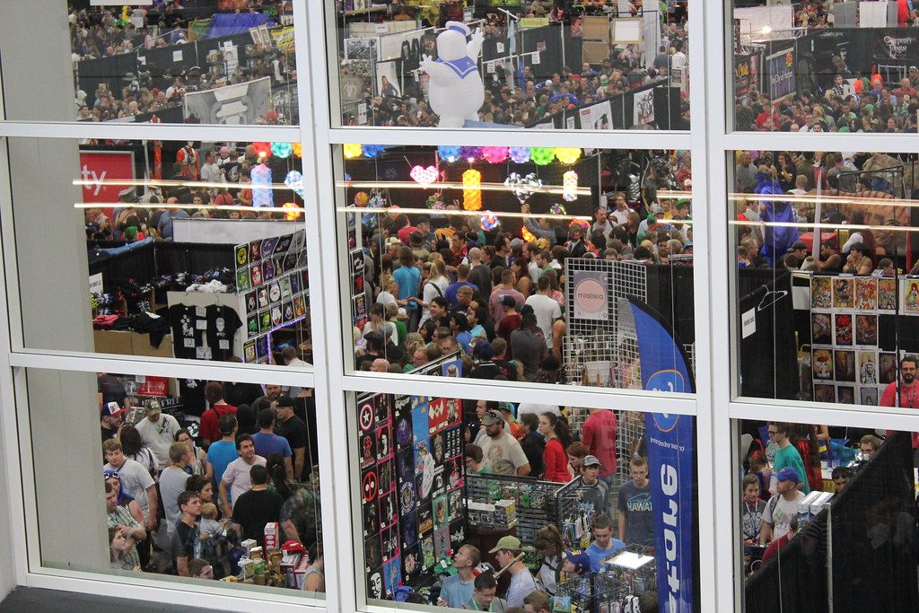 A packed exhibit floor seen through tall windows at Salt Lake Comic Con 2013