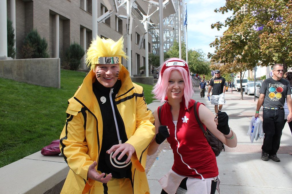 Two Naruto cosplayers smiling on the sidewalk outside Salt Lake Comic Con 2013