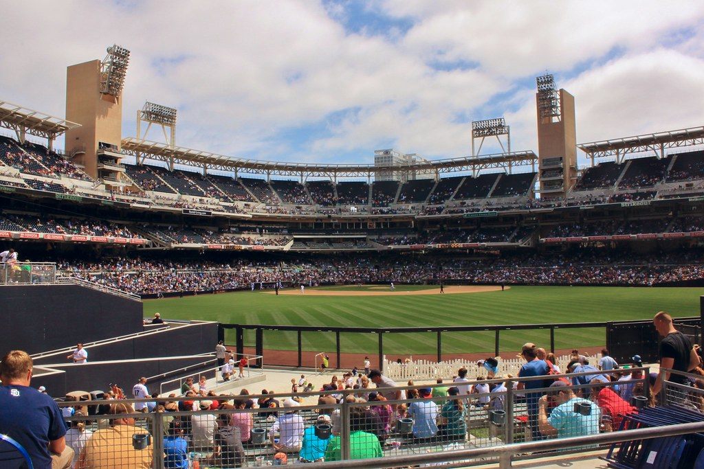 Fans filling the stands at Petco Park on a sunny game day, seen from the outfield seats