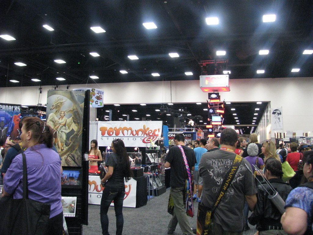 Attendees browsing artist and toy booths, including a Toy Munkee Studios stand, on the Comic-Con 2012 exhibit floor in San Diego