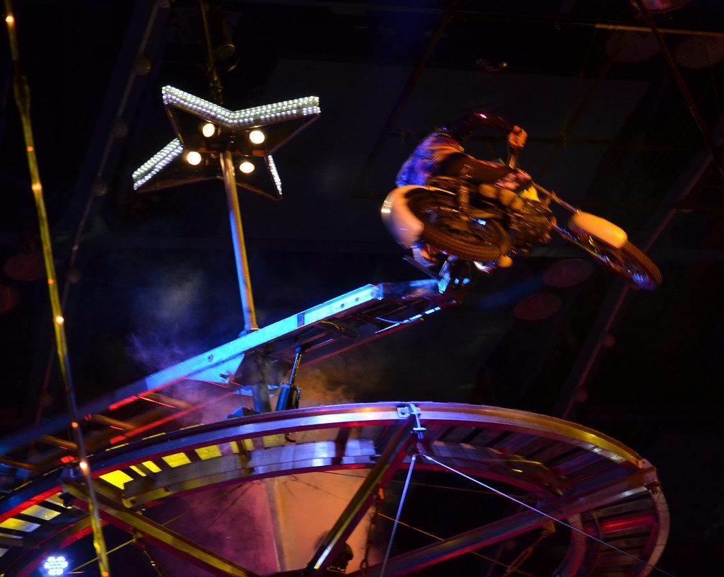A motorcycle rider launches off a lit ramp on a rotating steel wheel high above the ring at the Royal Hanneford Circus in Westchester, NY