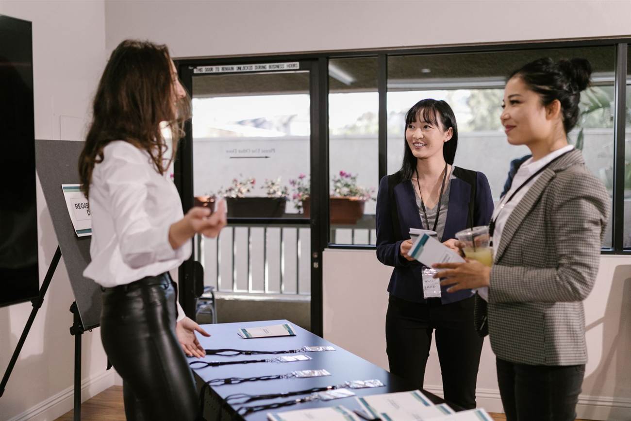 Attendees collecting lanyards at a registration desk