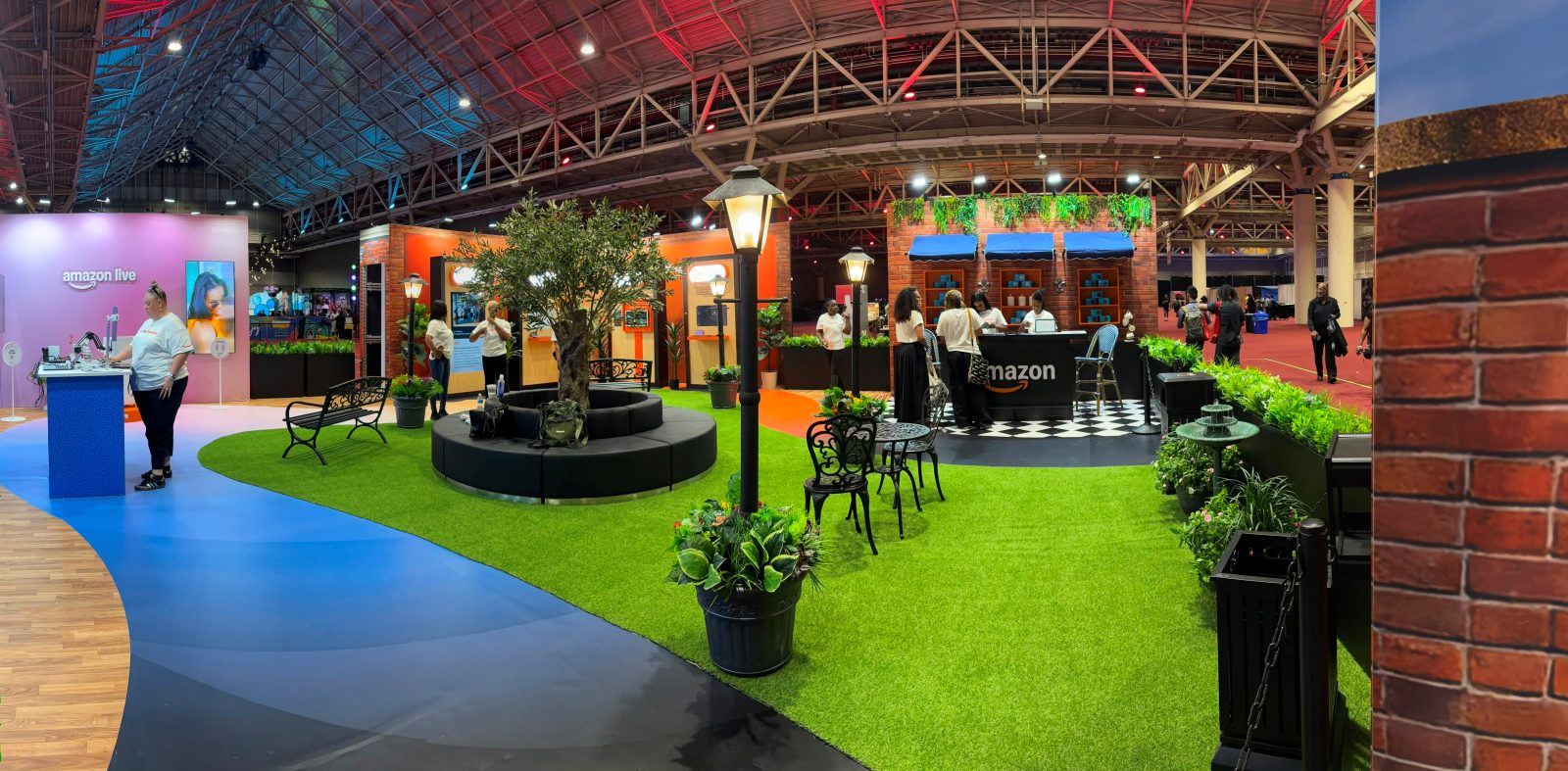 Amazon's walk-through brand space with French Quarter facades and a courtyard olive tree at ESSENCE Festival
