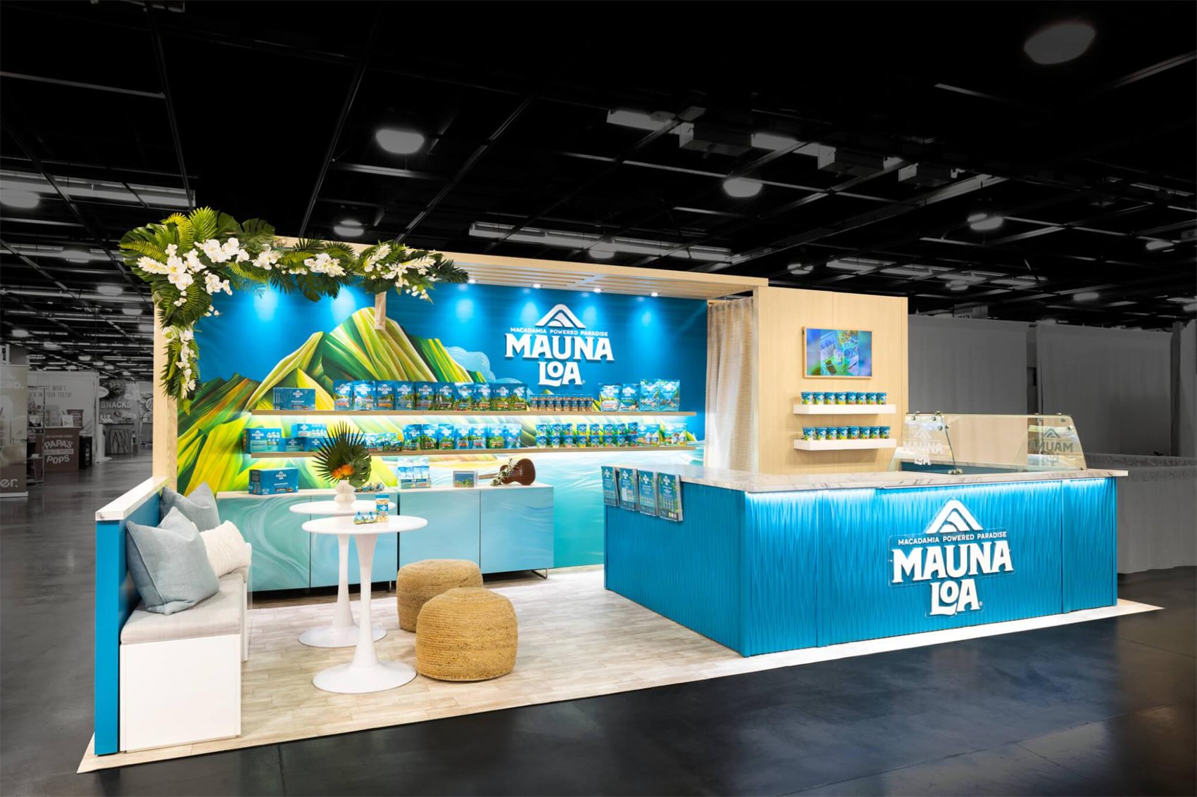 Design render of a 10×20 corner trade show booth: corner booth with bright blue counter and printed mural wall