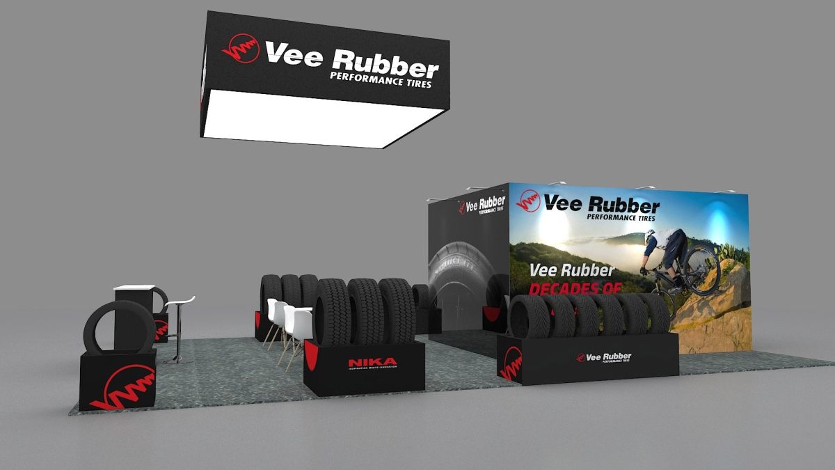 Design render of a 20×20 island trade show booth: island booth with square hanging sign and tire displays