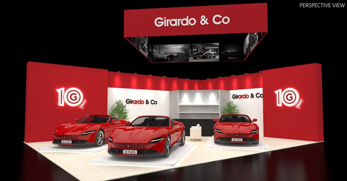 Design render of a 20×30 peninsula trade show booth: peninsula booth with red walls and hanging sign with screens