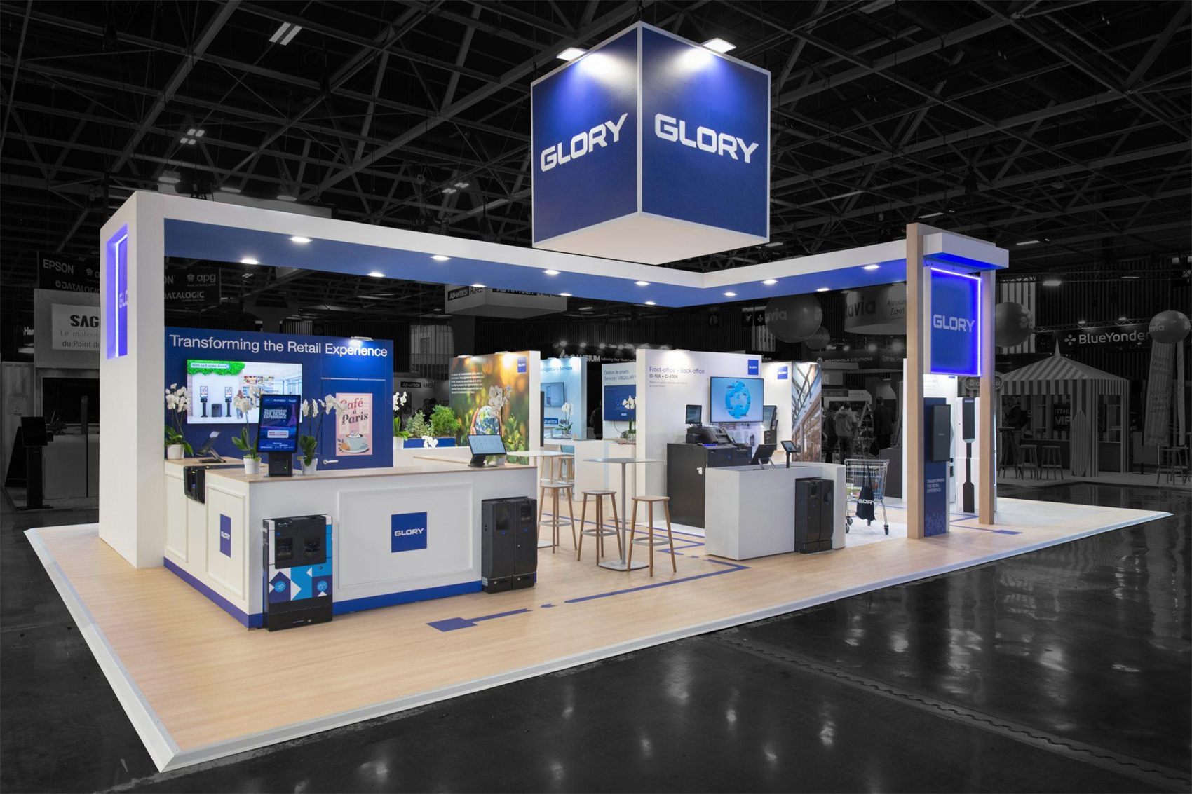 Design render of a 20×30 island trade show booth: island booth with overhead header frame and cube hanging sign