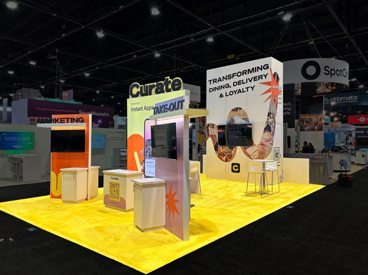 Design render of a 20×30 island trade show booth: island booth with tall printed wall and four screen stations