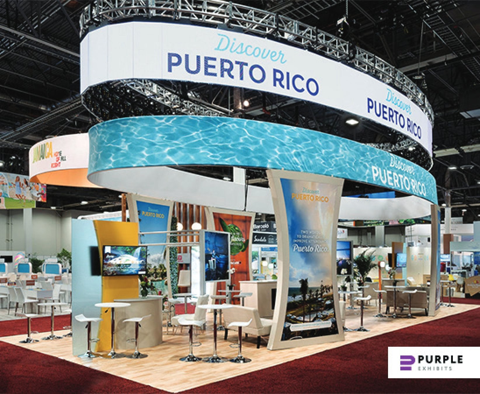 Design render of a 40×50 island trade show booth: island booth with two-tier oval hanging sign and curved graphic towers