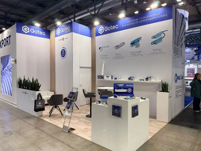10×20 Corner Booth With Tall Graphic Walls and Product Pedestals