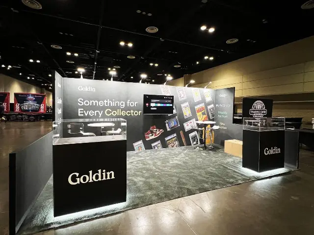 10×20 Inline Booth With Dark Printed Wall and Lit Display Cases