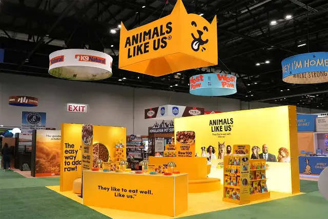 20×20 Peninsula Booth With Backlit Walls and Large Hanging Sign