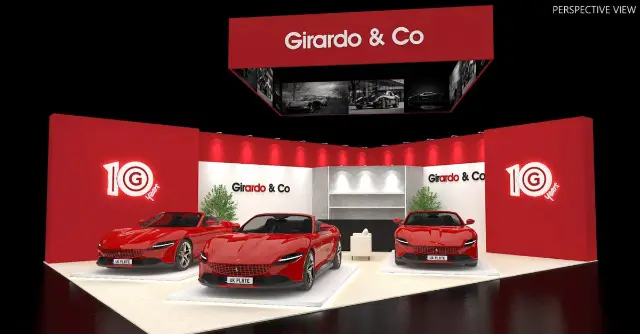 20×30 Peninsula Booth With Red Walls and Hanging Sign With Screens