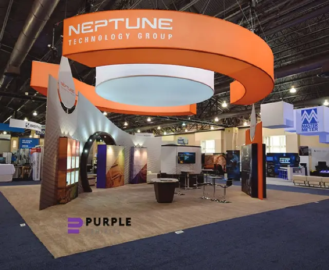 40×40 Island Booth With Spiral Ring Hanging Sign and Sweeping Curved Wall