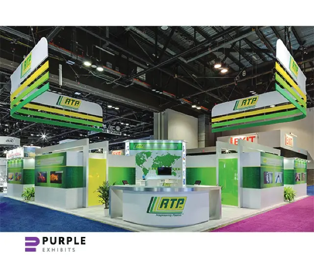 40×40 Island Booth With Twin Layered Hanging Signs and Curved Reception Counter