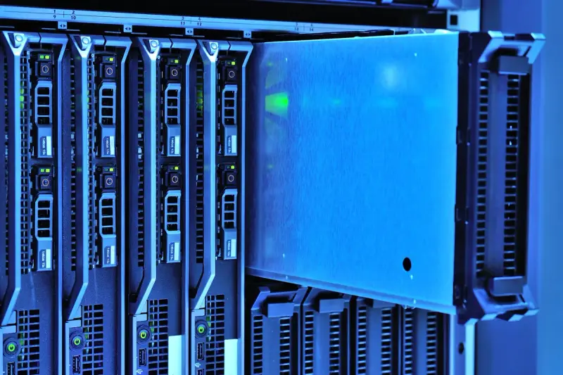 Blade servers with glowing indicator lights in a blue-lit rack