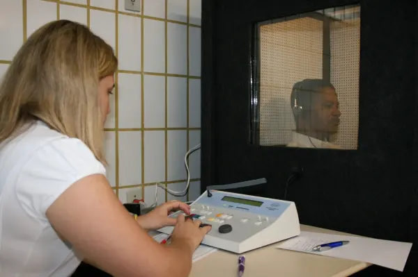 Professional conducting a hearing examination