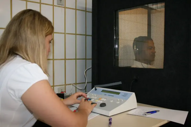 Professional conducting a hearing examination