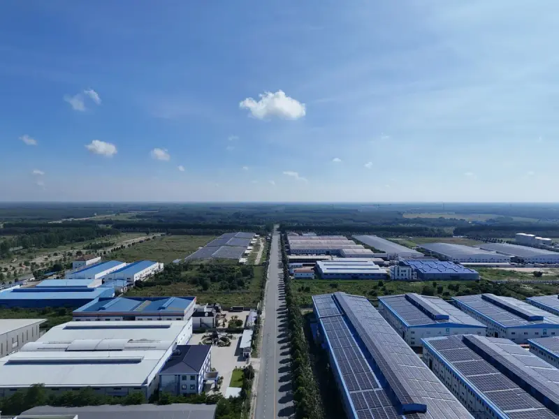 Aerial view of a large industrial park with factory buildings under a clear sky
