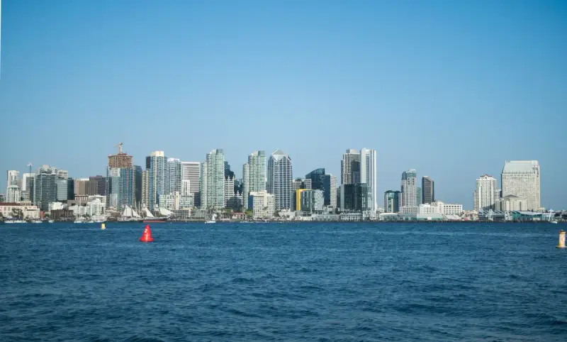 Downtown San Diego high-rises along the waterfront across blue San Diego Bay on a clear day