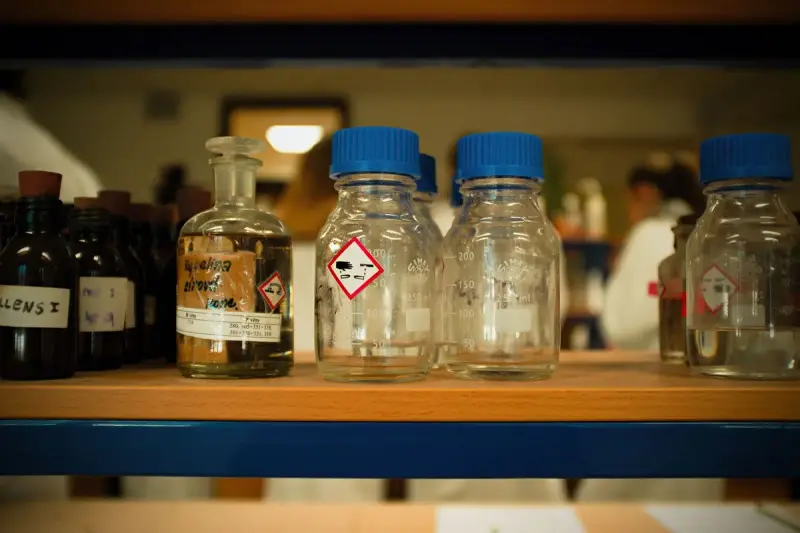 Glass bottles and containers on a laboratory shelf
