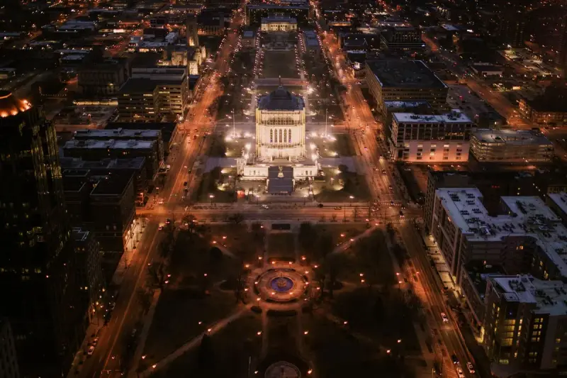 Aerial night view of downtown Indianapolis Mile Square with lit buildings and streets