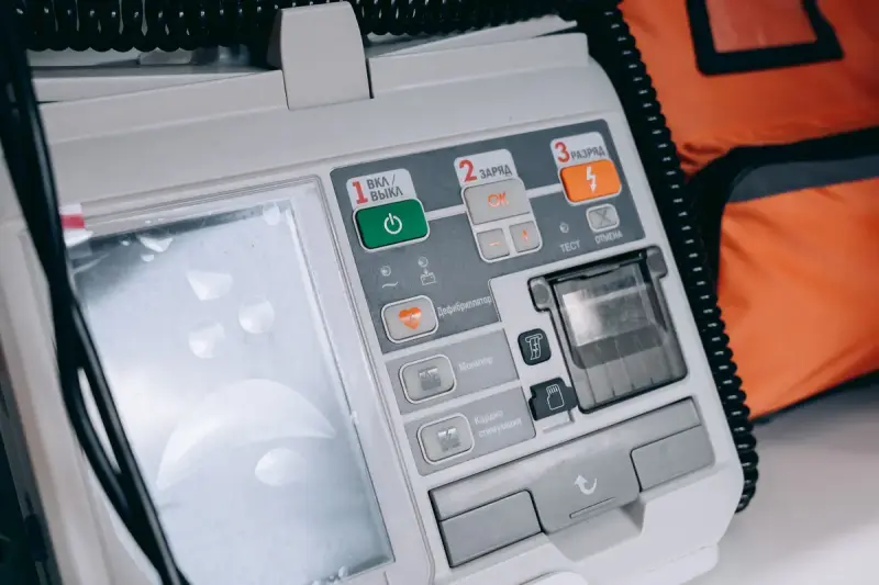 Close view of a defibrillator control panel with numbered power, charge and shock buttons