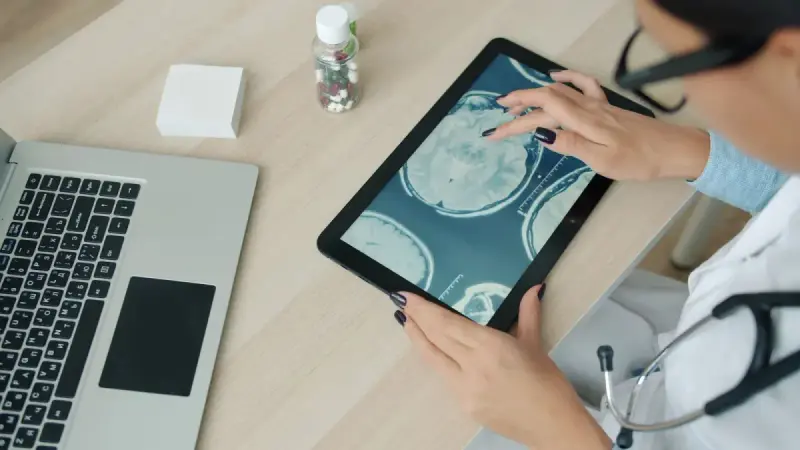 Medical professional reviewing brain scan images