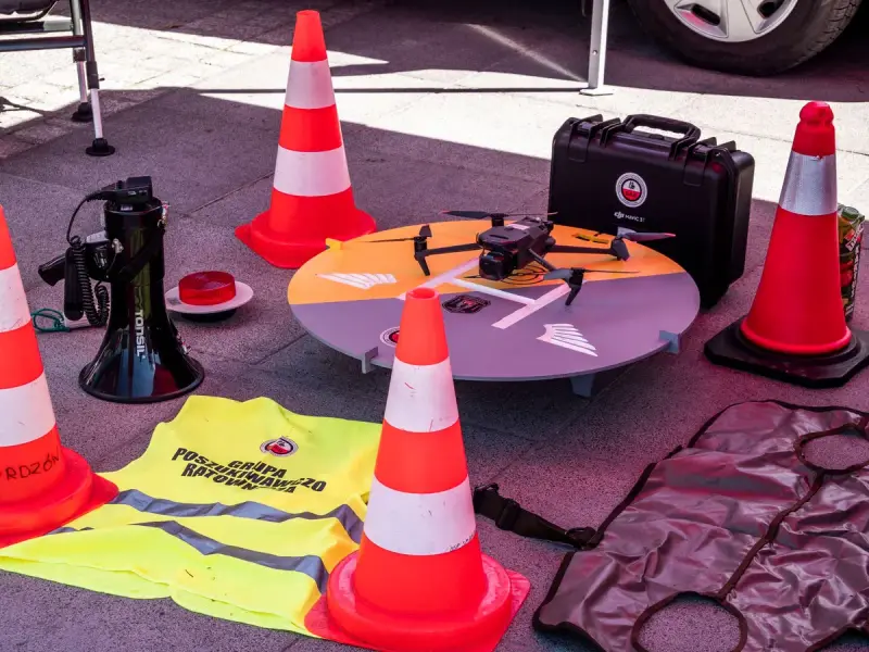 Inspection drone laid out with safety vests and traffic cones on a work site