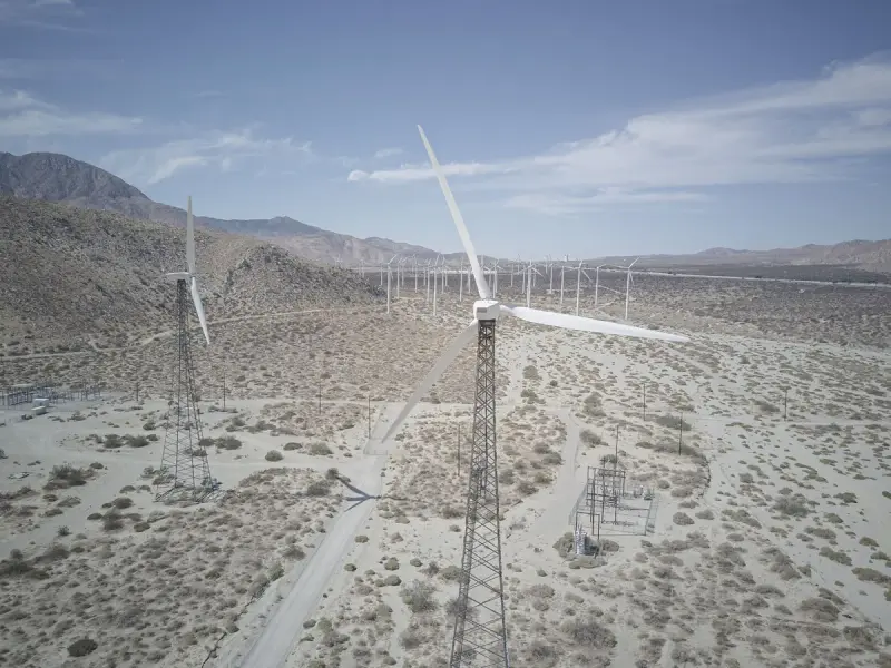 Aerial view of wind turbines standing in a California desert landscape