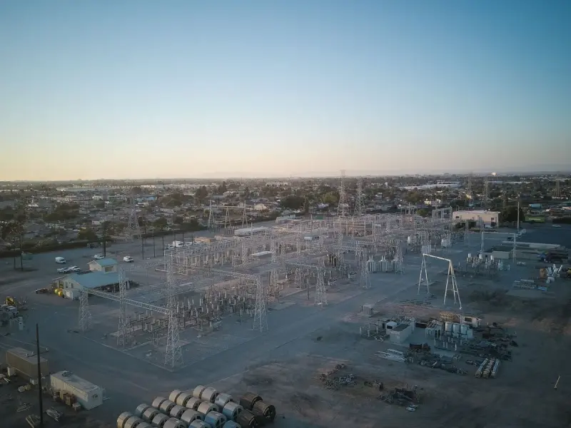 Wide view of a power station and its infrastructure at sunset