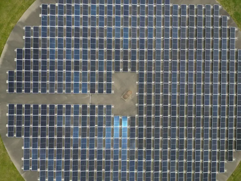 Aerial view of a large solar panel array in a field