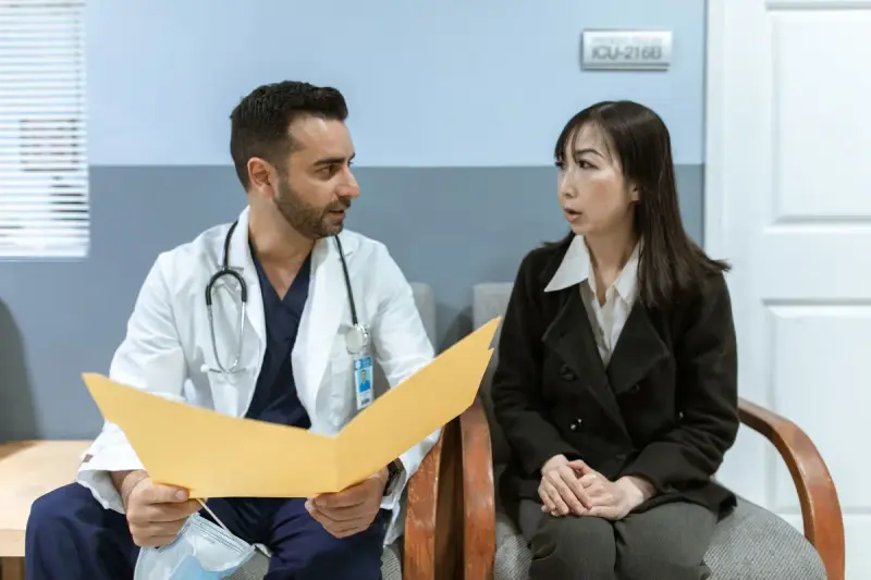 Healthcare professional consulting a participant in a clinical setting