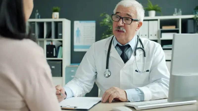 Experienced doctor talking with a participant in a medical office